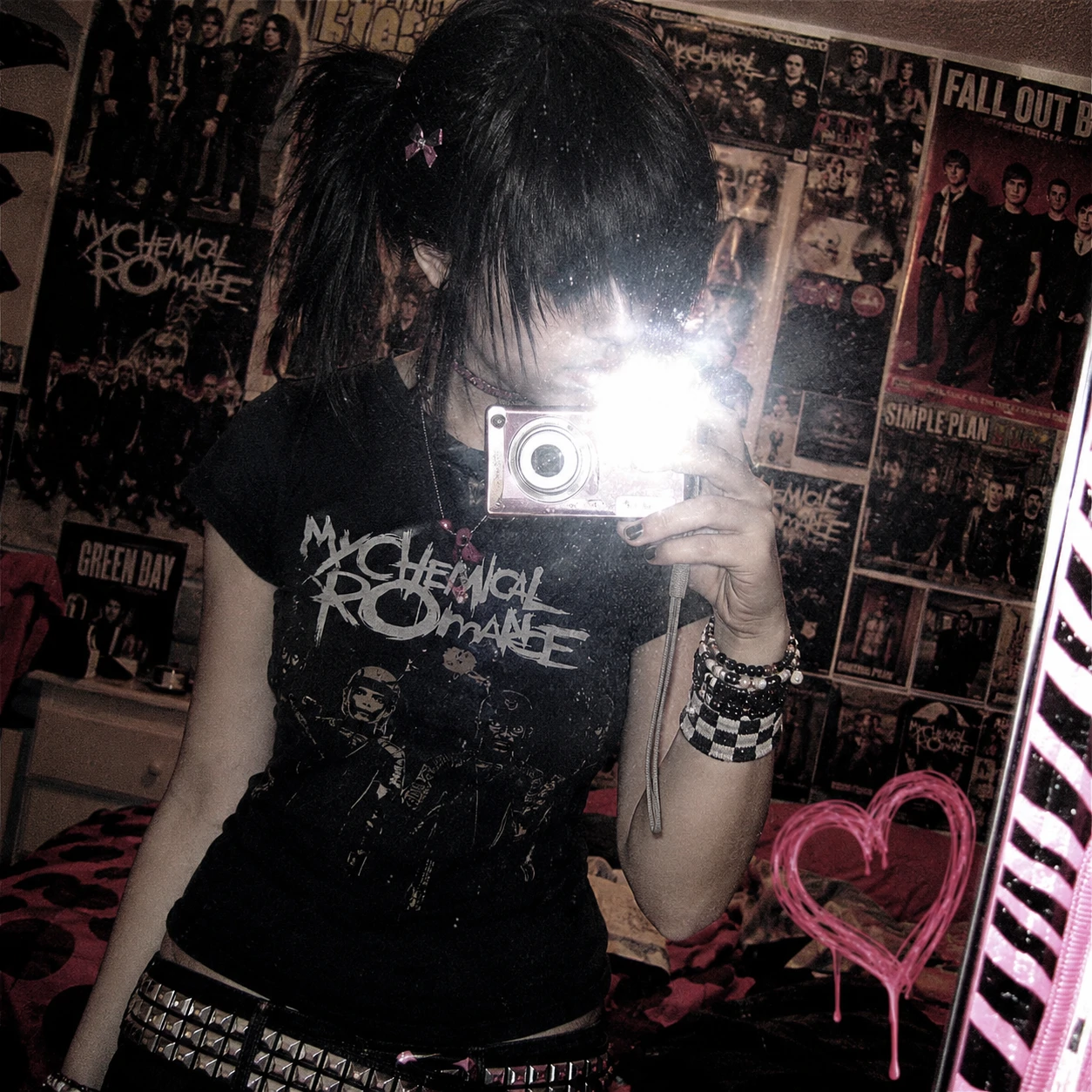Y2K emo PFP mirror selfie with a bright camera flash, band poster wall and side ponytail