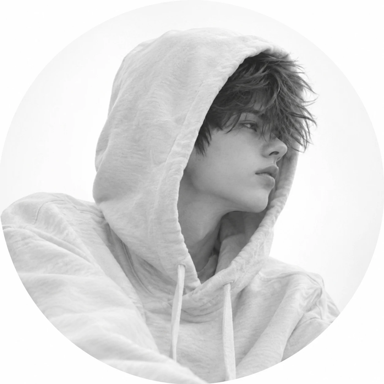 White PFP boy in a pale hoodie shot in soft monochrome tones